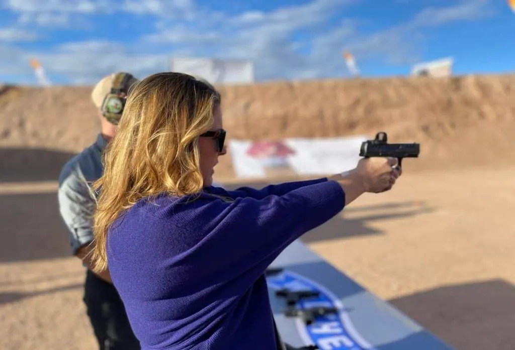 Carrie Miller holding handgun pistol woman shooting at range