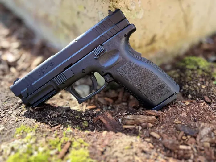 a close up of a springfield armory xd40 laying on the ground