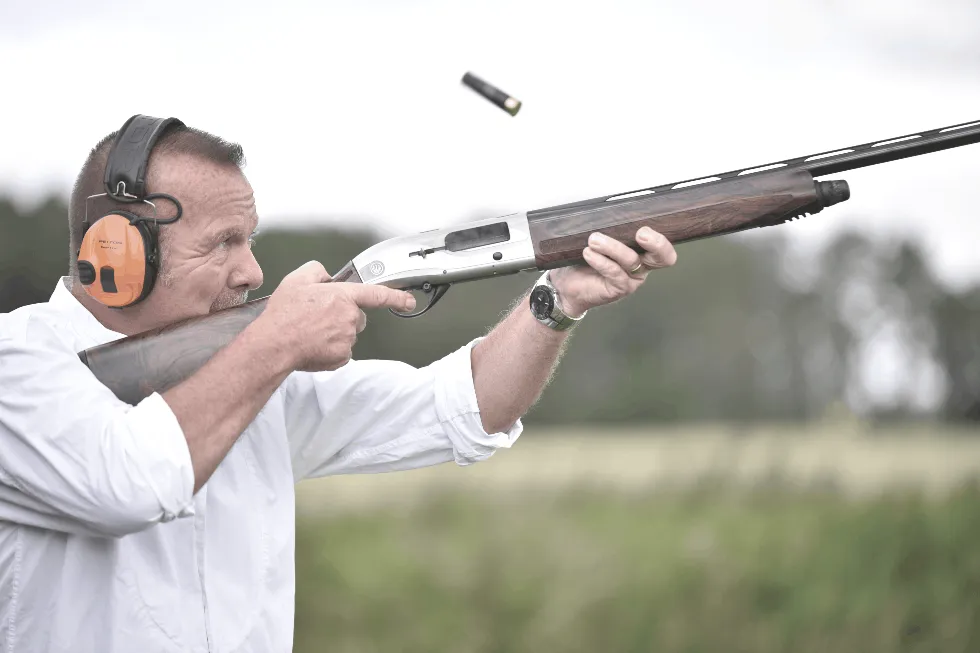 man shooting skeet clay pigeons on shooting range