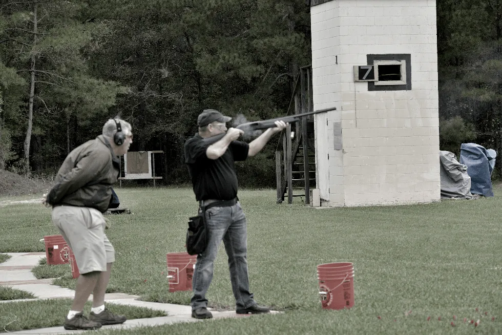 man shoots at a clay target used in skeet shooting