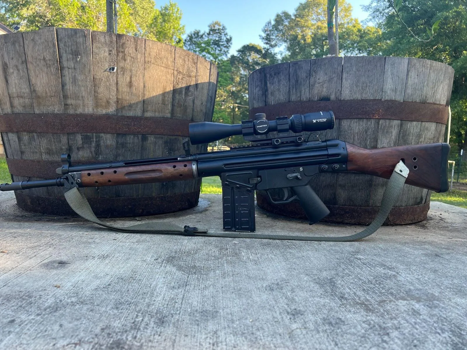 century arms c308 in front of two barrels