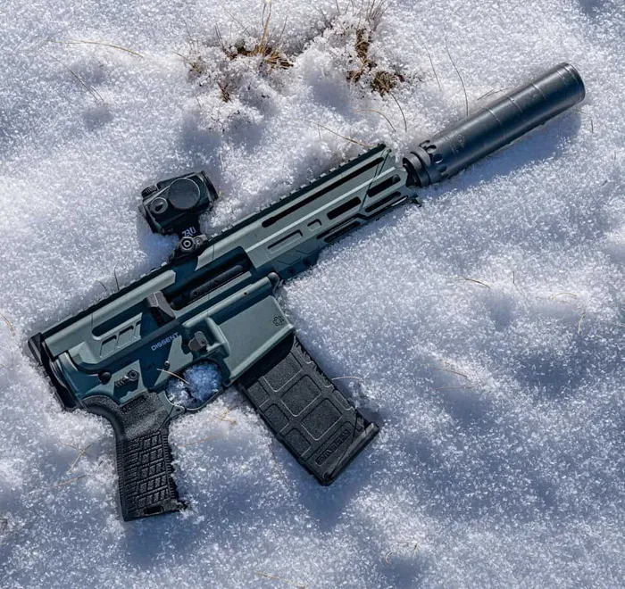 cmmg dissent with suppressor laying in snow