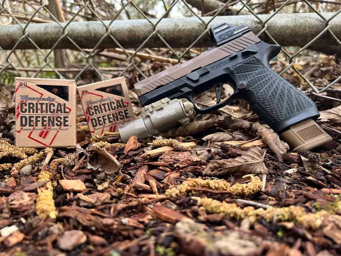 holosun 507c mounted on sig sauer p320 m18 with hornady critical defense ammo