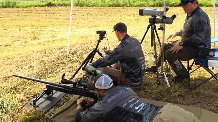 man scoped in with rifle long range