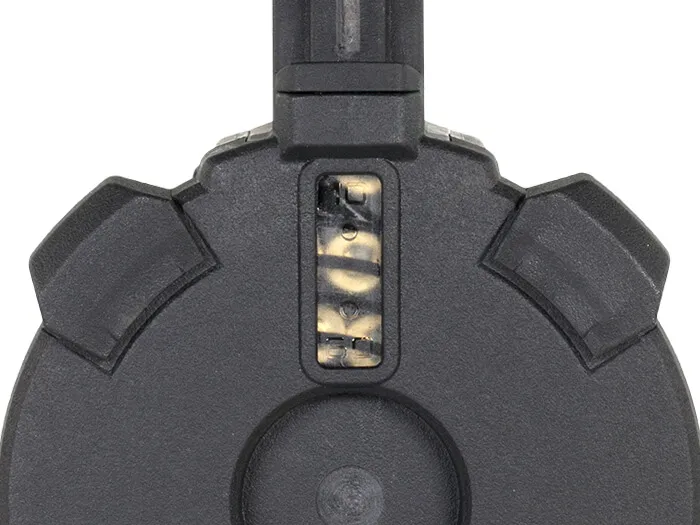 Close-up of the Magpul PMAG D-60 Gen M3 drum magazine's witness window, allowing users to visually check the remaining round count