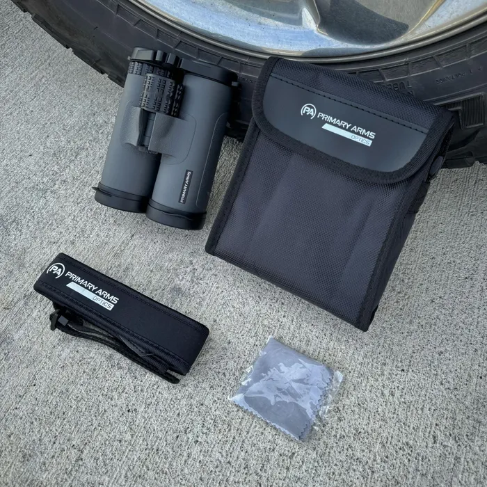 The GLx binoculars and accessories neatly arranged inside the provided soft carrying case