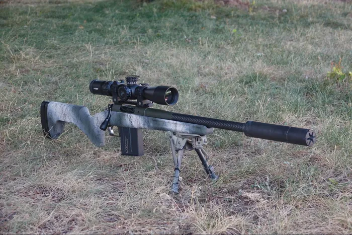springfield armory model 2020 redline review with a scope attached to it laying in the grass