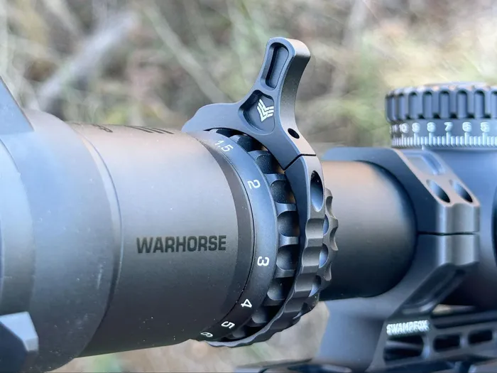 Close-up image of the Swampfox Warhorse LPVO showing the throw lever positioned near the 1x magnification mark, indicating the user's preference for lower magnifications