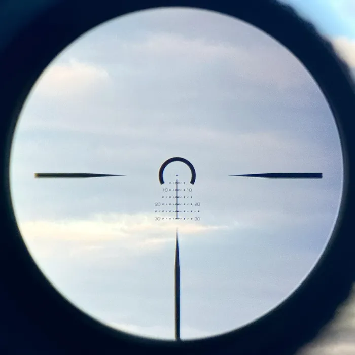Image showing the view through the Swampfox Warhorse LPVO with a focus on a distant object, possibly a cloud, to illustrate the optic's range capability